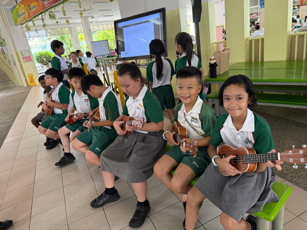 Students practising ukulele together during a school music lesson.